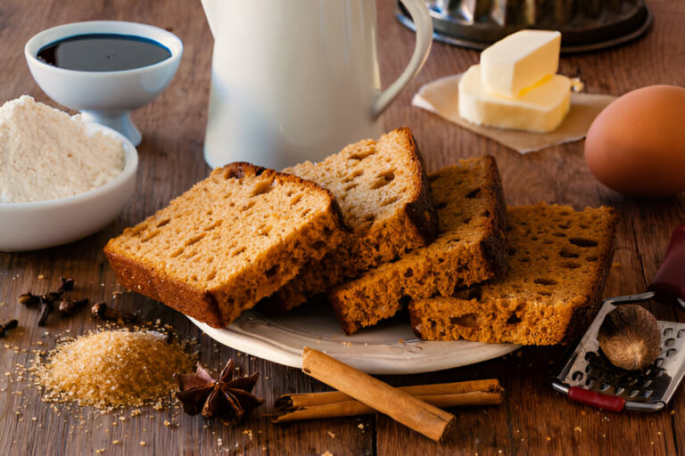 Sliced bread with various baking ingredients including flour, sugar, butter, and spices on a wooden table