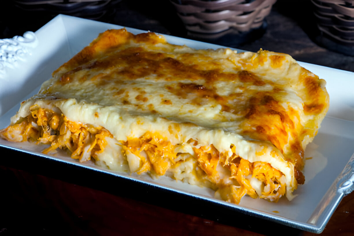 A delicious serving of cheesy lasagna on a decorative plate, showcasing layers of pasta, cheese, and filling.