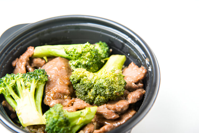 A delicious dish of broccoli and beef in a black bowl.