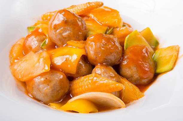 A delicious dish featuring meatballs and assorted vegetables in a sweet and tangy sauce.