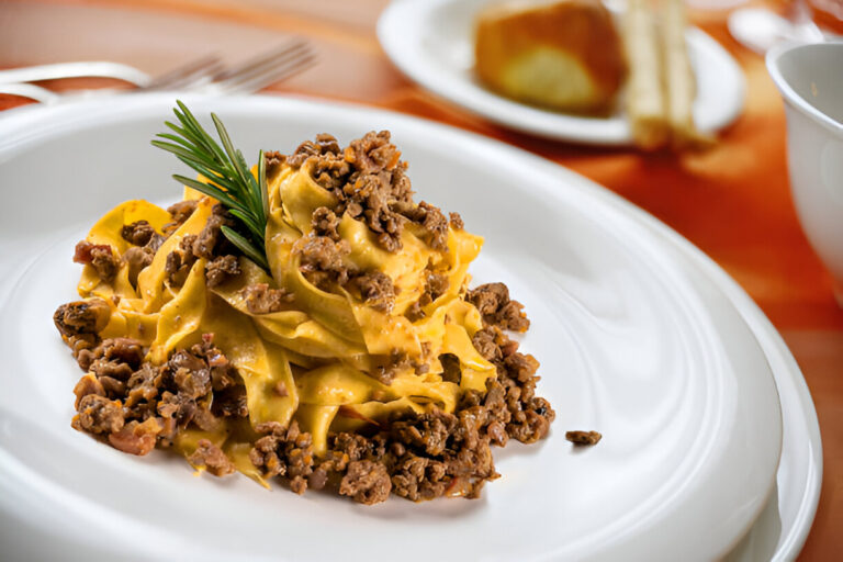 Plate of pasta with beef on a white dish