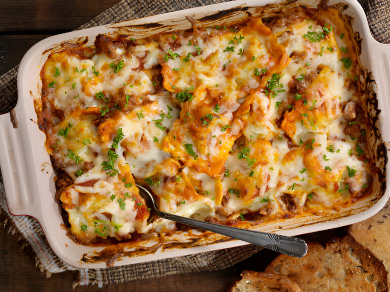 A delicious baked pasta dish with layers of cheese, meat, and sauce in a casserole dish.